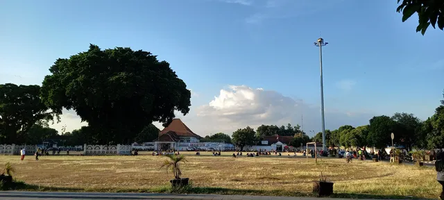 Beringin berpagar dan ruang Alun-Alun Selatan Yogyakarta dengan pengunjung, foto arsip 2021 / Fenced banyan and the South Square of Yogyakarta with visitors, archive photograph from 2021