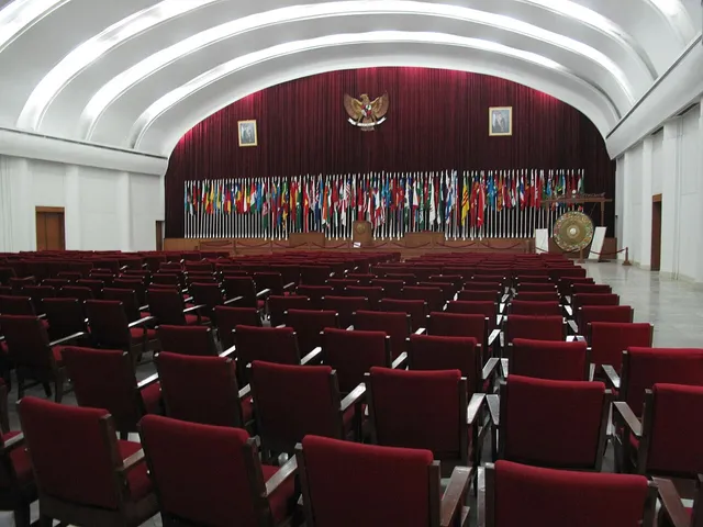 Ruang konferensi Gedung Merdeka dengan kursi merah dan panggung, Januari 2010. / Gedung Merdeka conference hall with red seats and stage, January 2010.