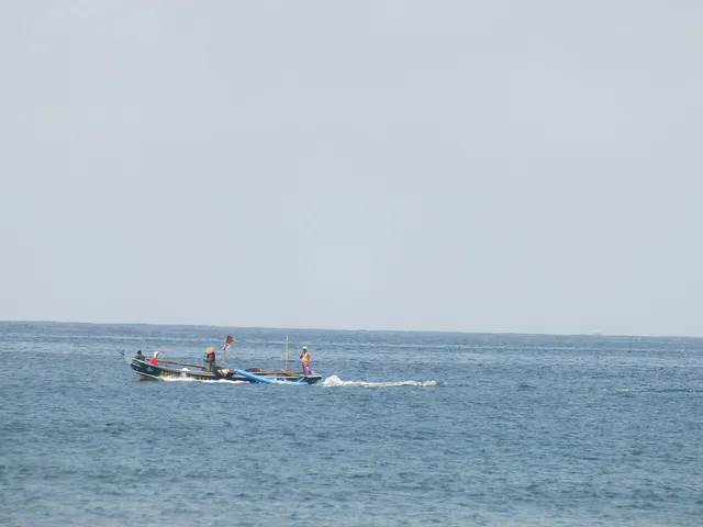 ID: Perahu nelayan di perairan Pantai Pangandaran. EN: A fishing boat off Pangandaran Beach.
