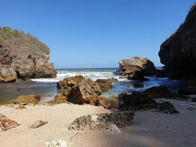 Pasir, batu dan laut di antara tebing Pantai Wohkudu, Juni 2019 / Sand, rocks and sea between Pantai Wohkudu cliffs, June 2019